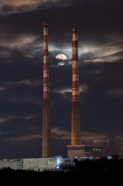 Poolbeg Chimneys with the Full Moon rising between them from Sandymount Strand.