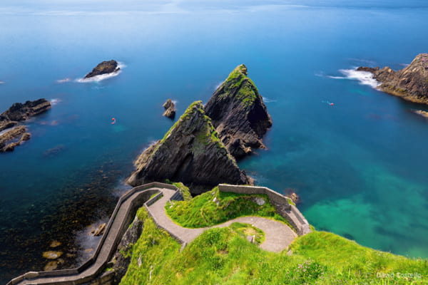 Looking over Dunquin Bay and down the winding road to Dunquin Pier on a bright summers day in Kerry.