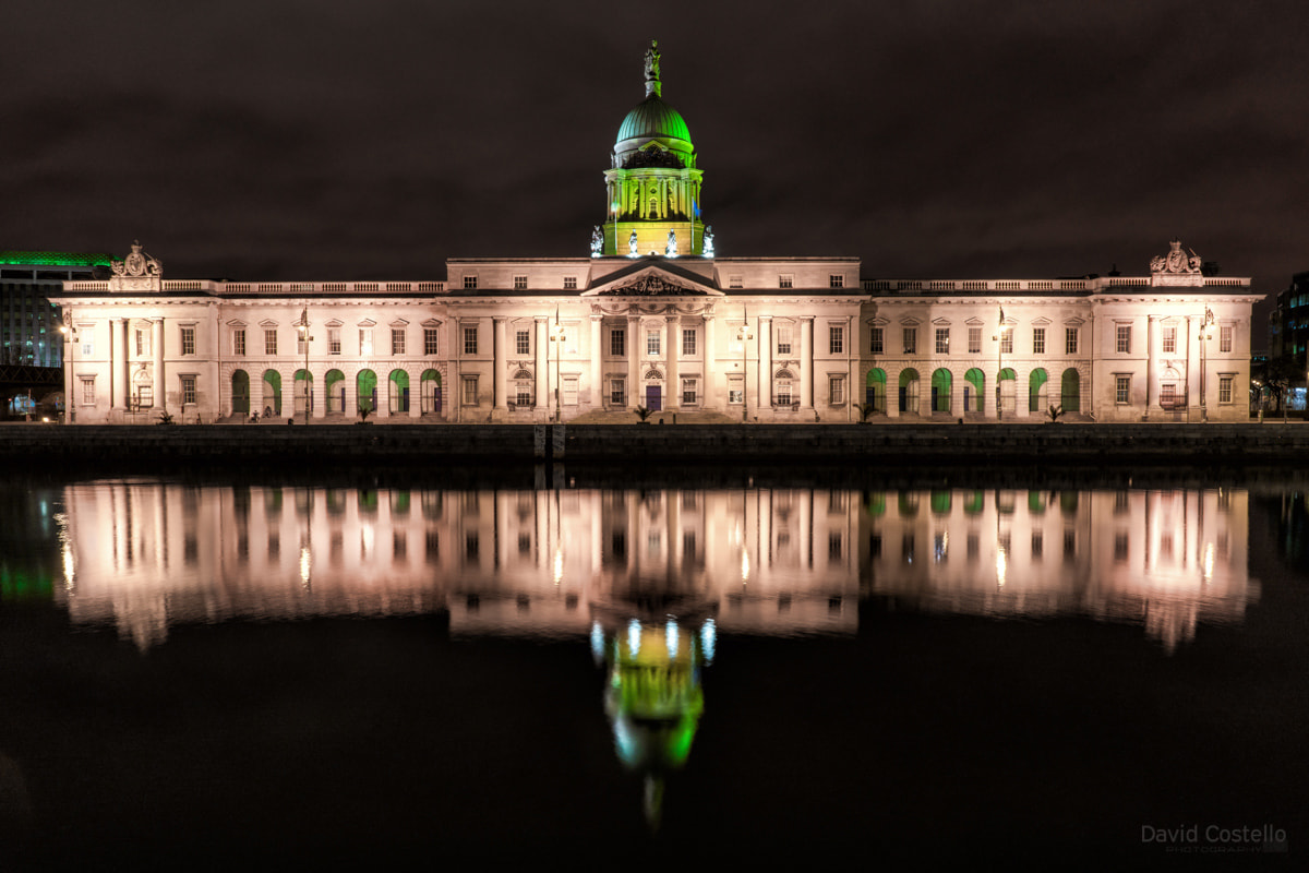 The Custom House lit up in green for the 2017 St. Patrick's Day celebrations while Dublin City slept and the light reflected across the river Liffey.