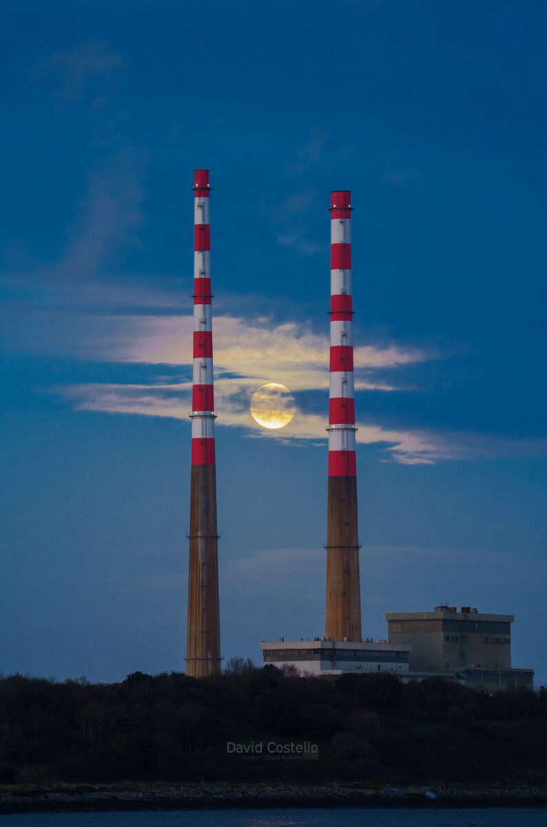 The moon rises between the newly repainted Poolbeg Chimneys on a beautiful November evening along Sandymount Strand.