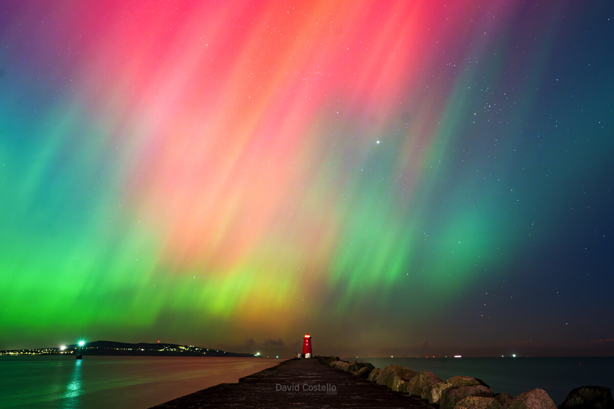 the aurora borealis above the poolbeg lighthouse in dublin bay.