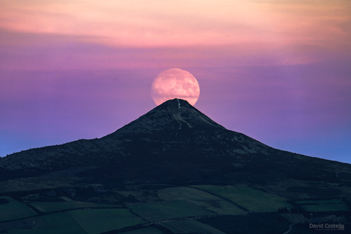 The Full Moon rising above the Sugarloaf in Wicklow at sunset.