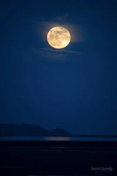 The Full Moon rising above the Baily Lighthouse in Howth.