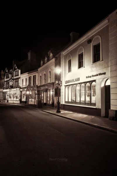 Dalkey Village empty on a Winter night in black and white with sepia tone.