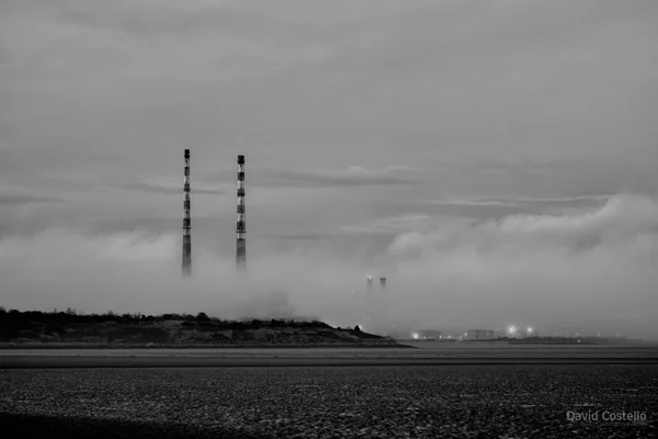 Fog coming in from Dublin Bay and wrapping around the base of the Poolbeg Chimneys.