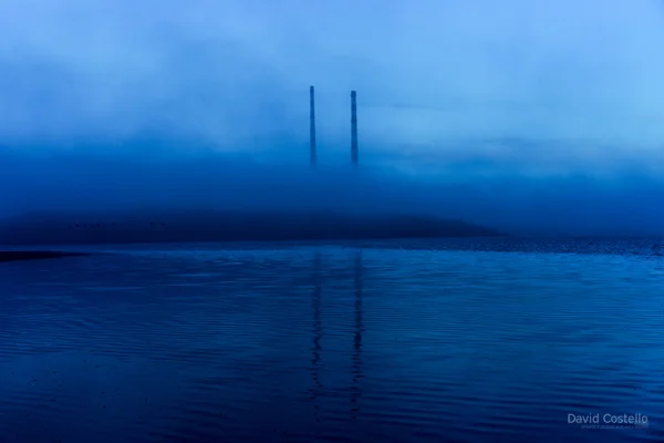 A winter fog rolls in around the Poolbeg towers in Dublin.