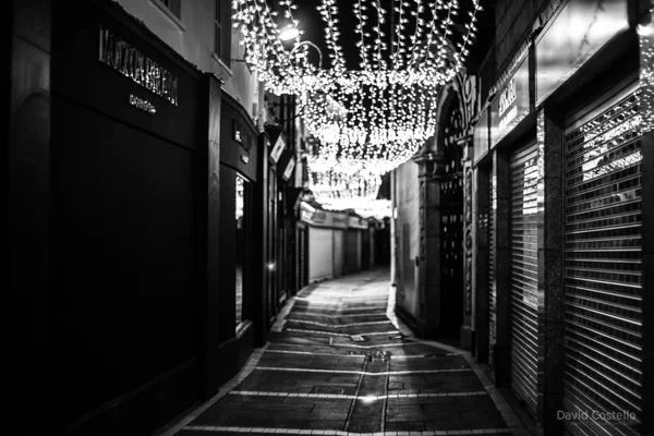 Johnson's Court's vibrant Christmas lights on Christmas Day in black and white.