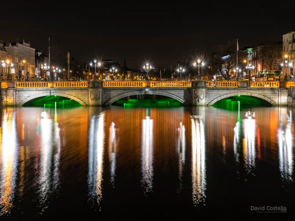 O'Connell Bridge with green, white and orange lighting for St. Patrick's Day in Dublin.