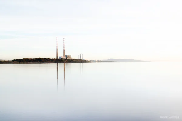 Dublin Towers reflecting brightly on the waters of Sandymount Strand.