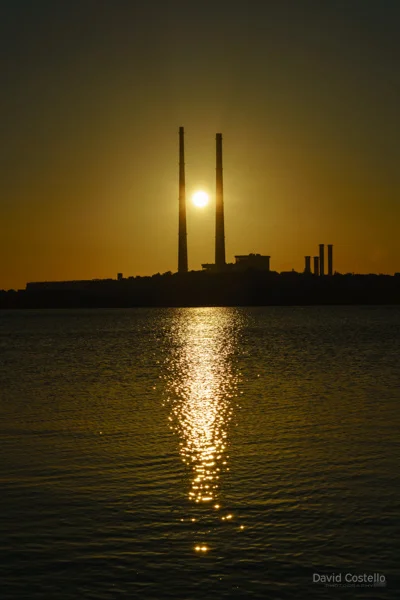 The sunrising between the Dublin Chimneys and reflecting in the water.